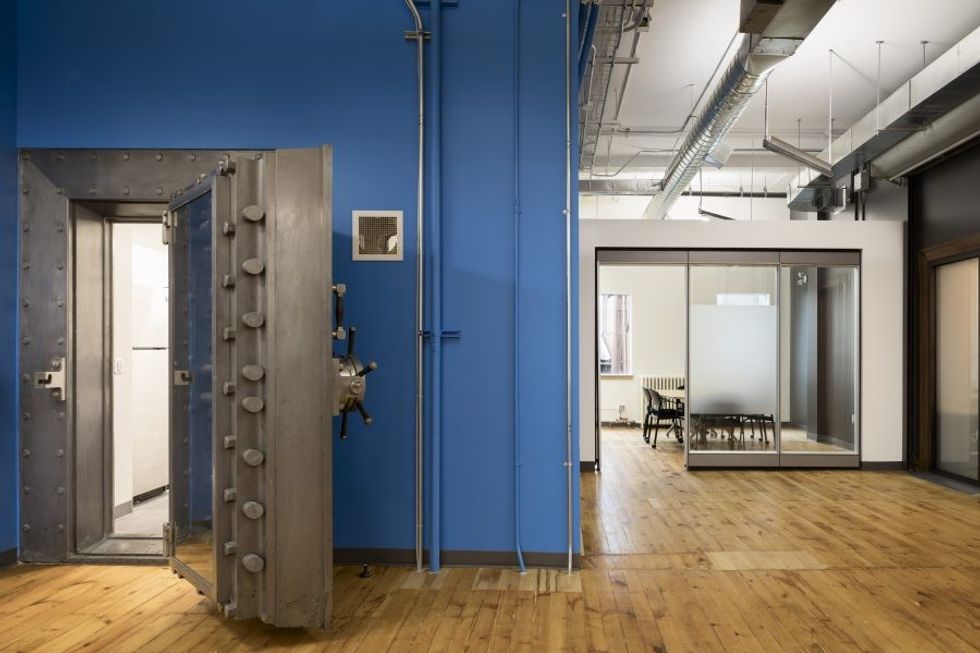 14 Erb St. West is a flexible work and meeting space with multipurpose collaborative furniture. A reclaimed bank vault door provides access the work spaces. Meeting rooms are located around the perimeter of the building with glazing to allow natural light deep into the buildings core.