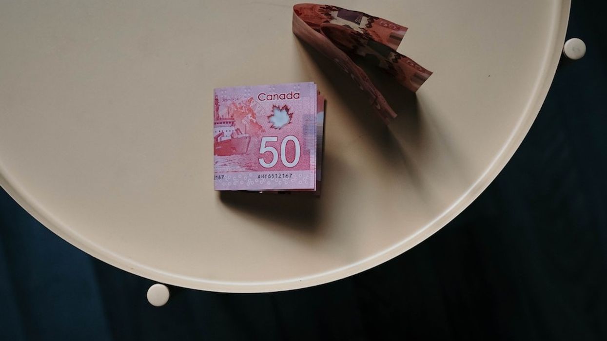 $50 bills on a white table