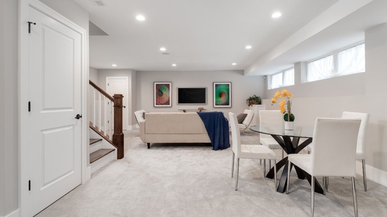 A basement with a dining table and living room.