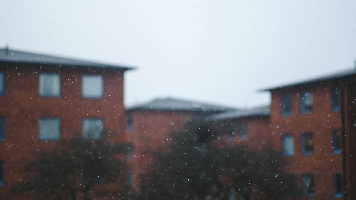 a blurry picture of a building and trees in the snow