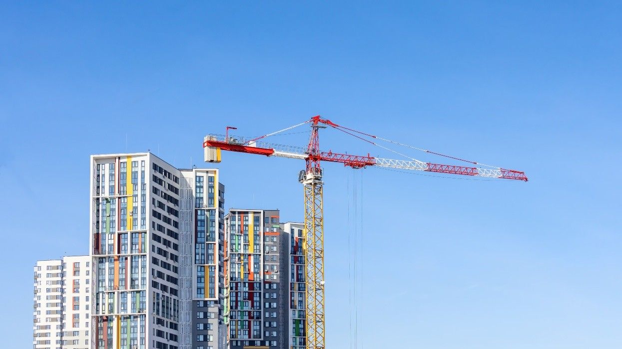 A crane next to several high-rise buildings.
