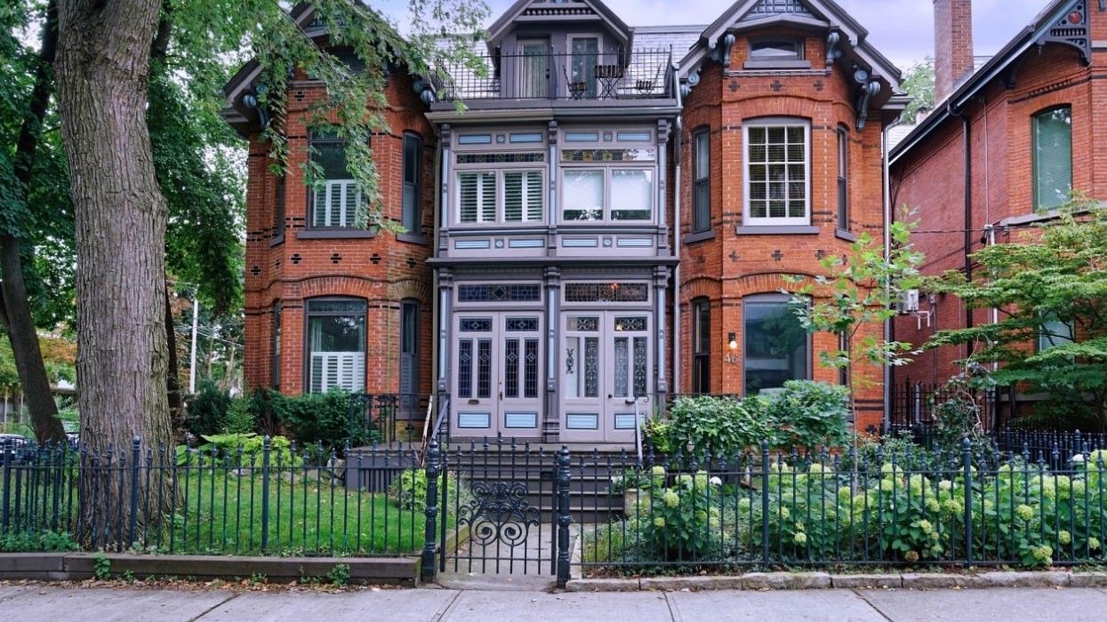 A pair of semi-detached brick Victorian houses in Toronto.