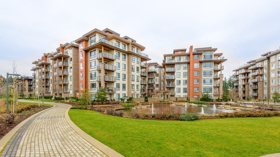 A pathway leading to a group of apartment buildings in Vancouver.