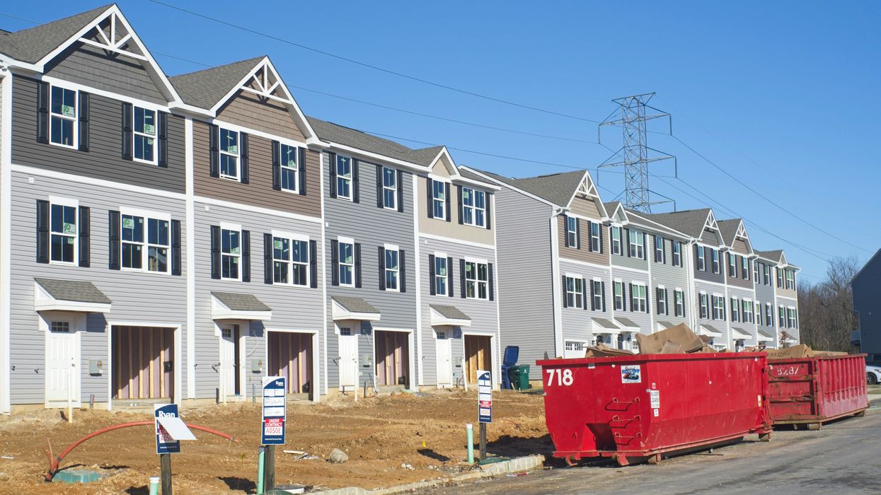 a row of houses with a red truck parked in front of them
