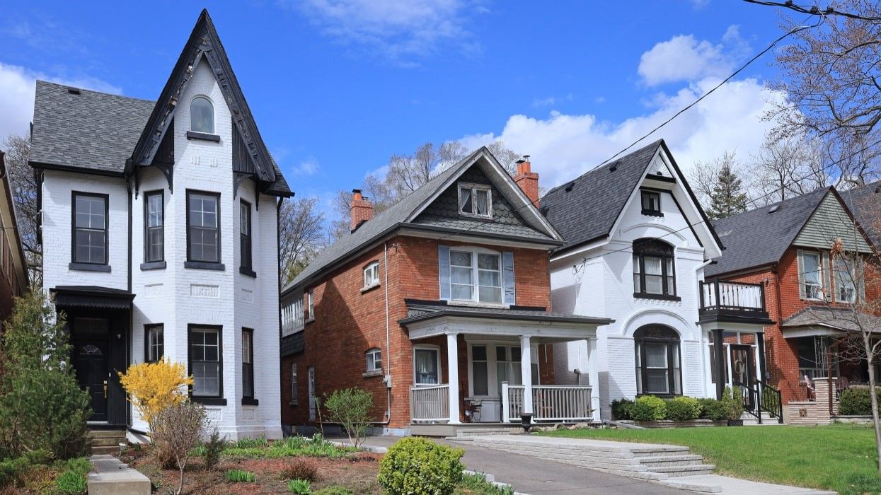 A row of white and red brick houses in Toronto.