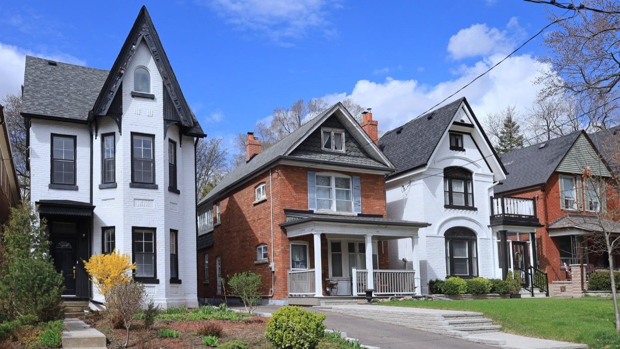 A street of detached brick houses in Toronto.