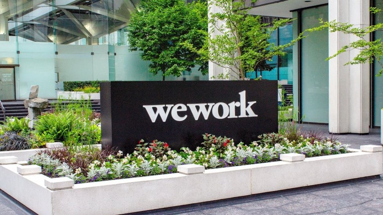 ​A WeWork sign outside an office building in Vancouver.
