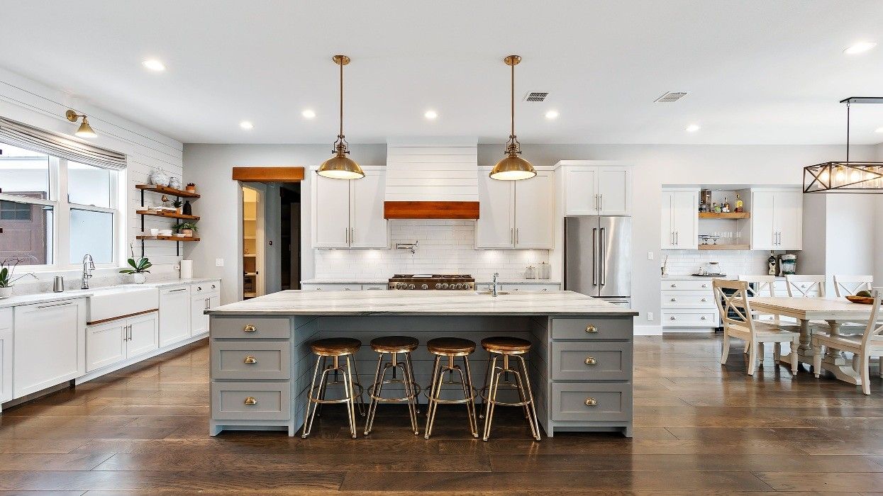 An interior photo of a home's kitchen and dining room.
