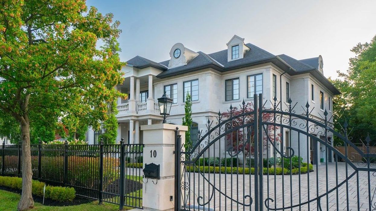 Angled view of luxury home with gated entrance