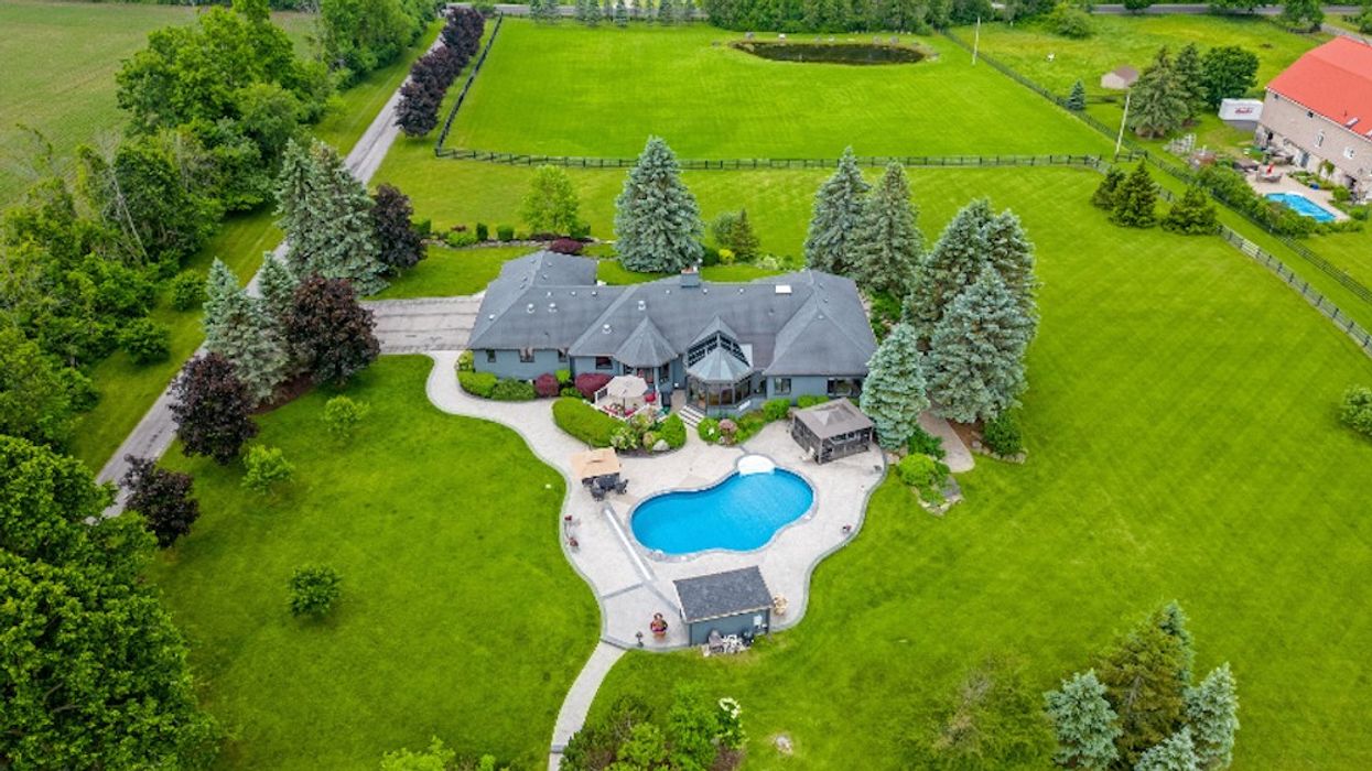 Birds-eye view of rural home with pool and lush lawn