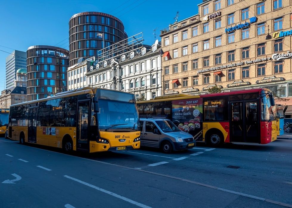 Buses driving on a public road in in Copenhagen, Denmark