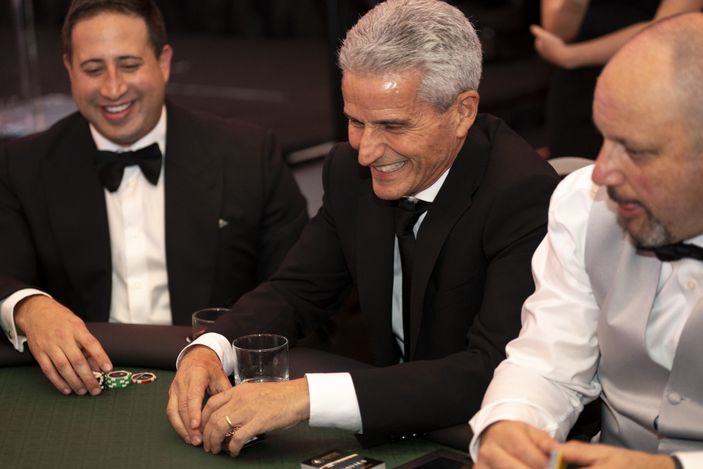 CentreCourt CEO and Hold'em For Life Board Member Andrew Hoffman (centre) playing a game of Texas hold'em. 
