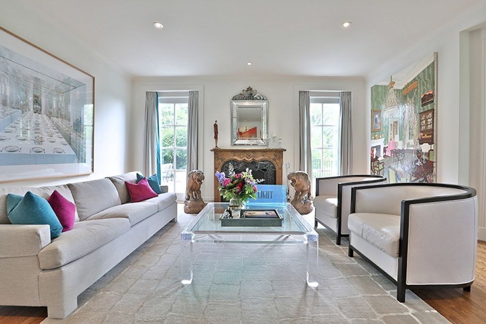 Cozy (and beautiful) area by the fireplace. Behind the couch is a photograph by Candida Hoffer from a gallery in Germany of a princess' set of china. 