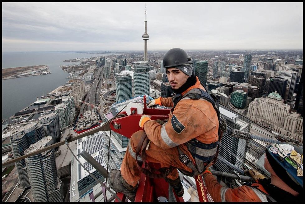 Crane Rigger, Marco Ottorino, sits at the apex of Harbour Plazas East Tower Crane as it is taken down in February. The photography for this project took place at the Harbour Plaza and the One York Street site over the past four years.