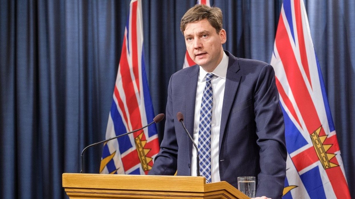 David Eby standing at a podium.