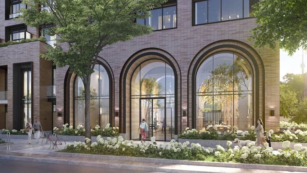 Entry to modern condo with large arched windows, with floral landscaping
