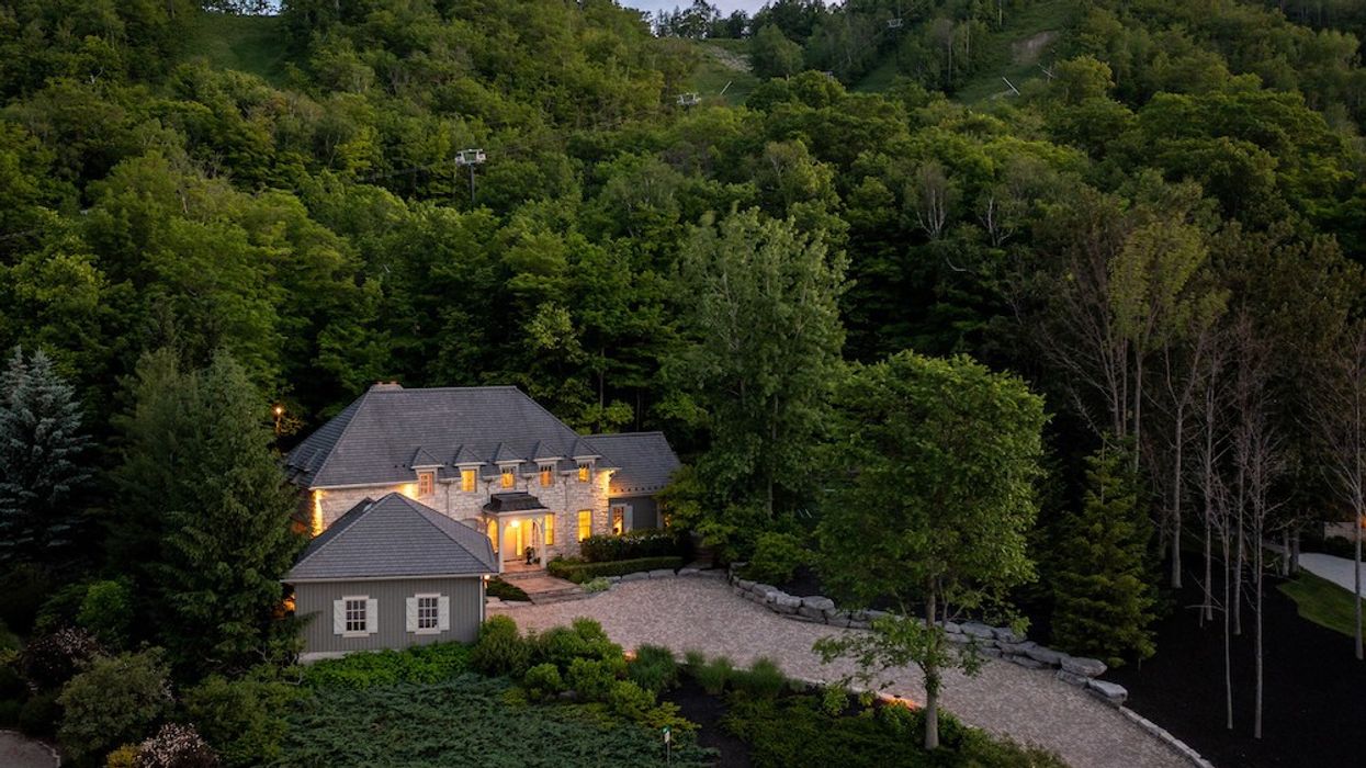 Grand home nestled amongst lush trees at dusk