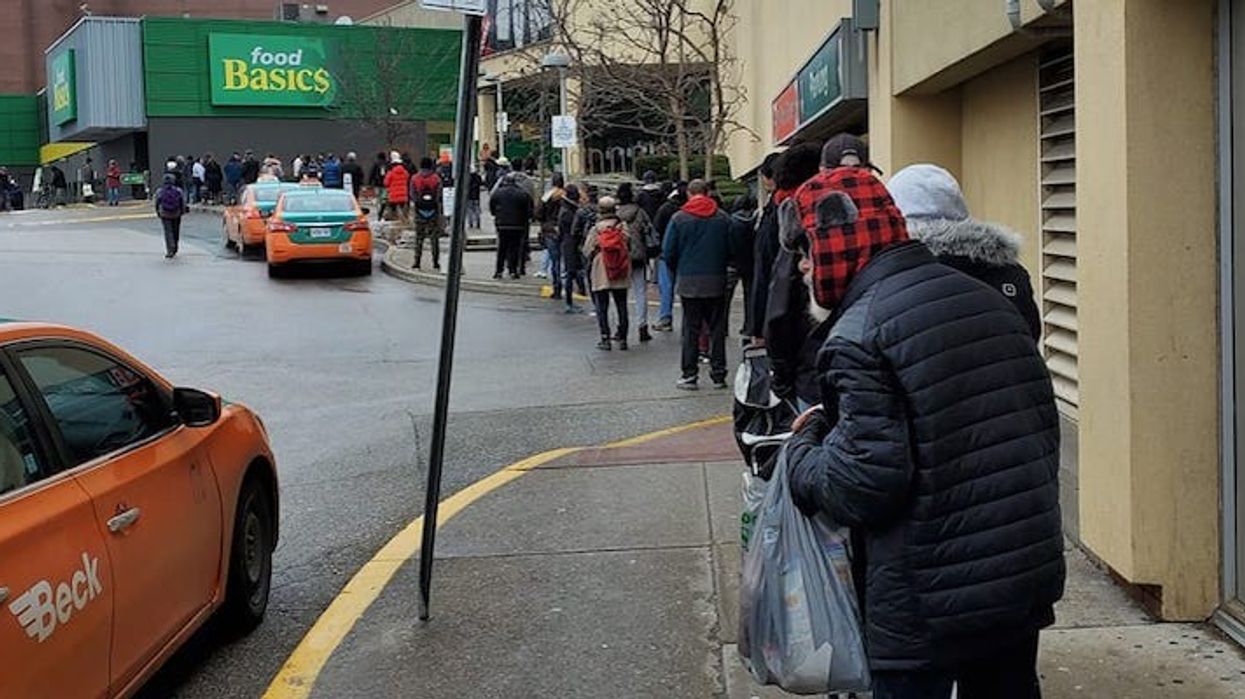 people lining up outside grocery store