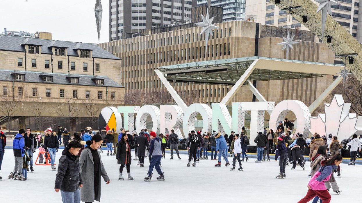 People skating at Nathan Phillips Square in Toronto.