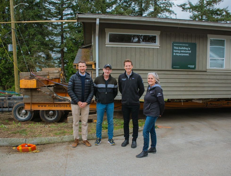Renewal Founder Glyn Lewis (third from left) in front of a home sitting on a truck.