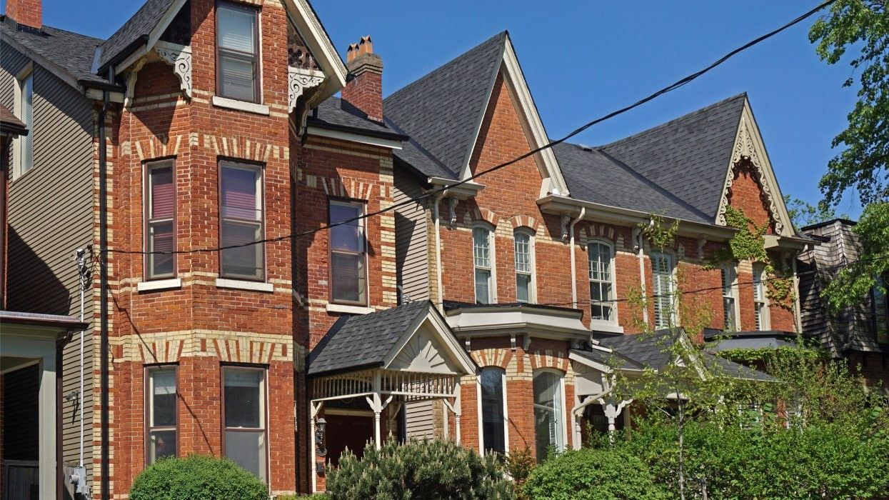 Semi-detached red brick Victorian houses.