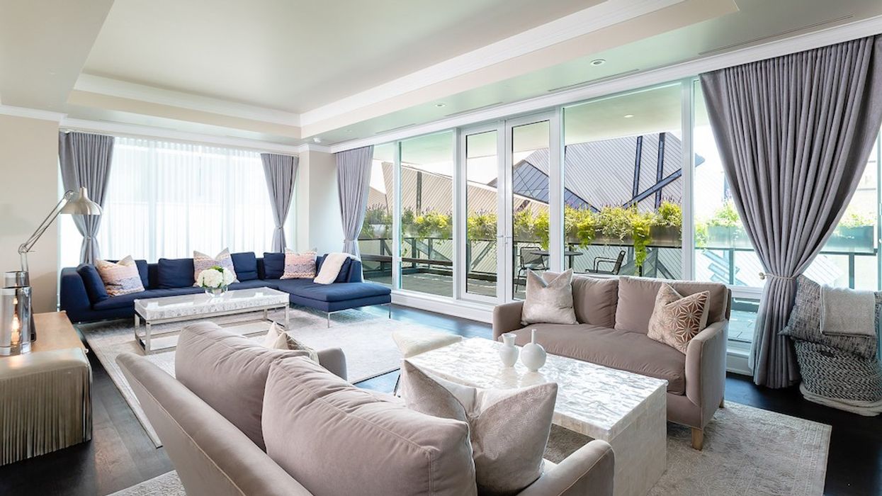 Sun-soaked living room with view of ROM through windows