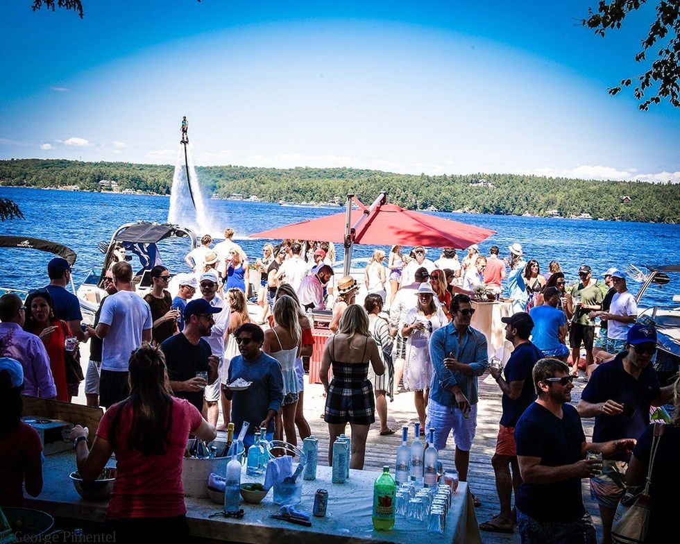 The flyboarders of Muskoka Wake add a fantastical backdrop to the party at the cottage owned bysocialites Tamara Bahry and Rod White.(Photo by George Pimentel for Commission Yourself)