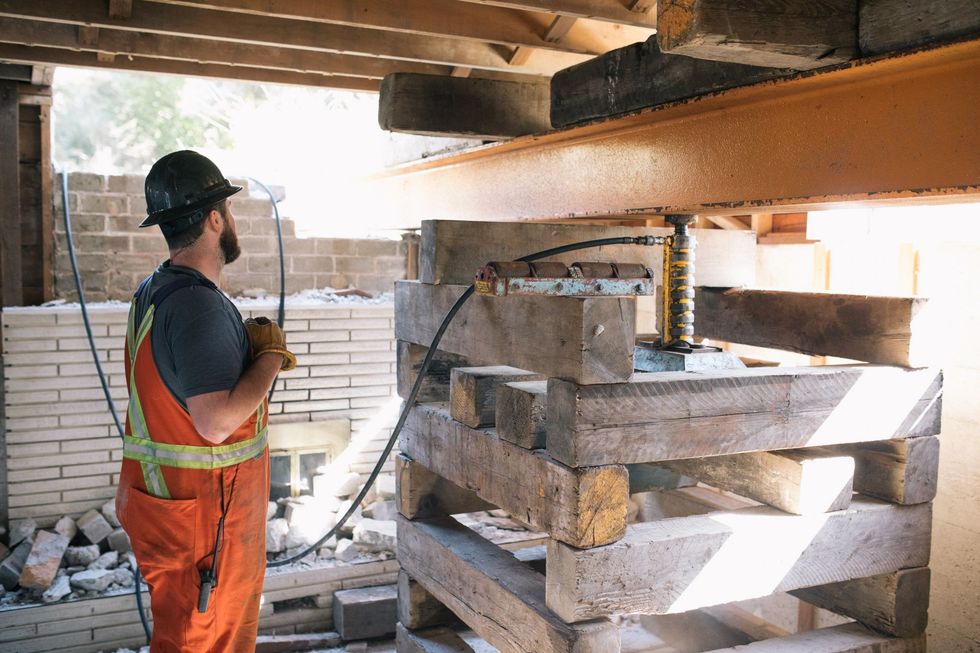 \u200bHomes get lifted up using hydraulics.