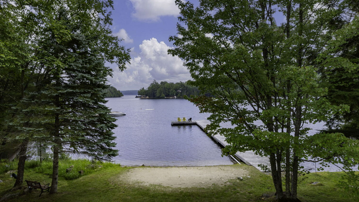 View of private beach, dock, and lake 